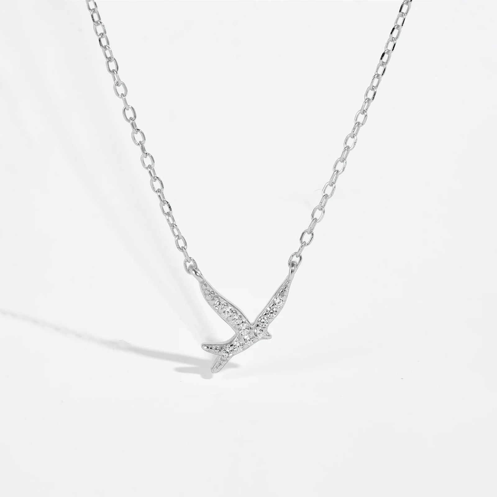 Bird pendant necklace symbolizes freedom, hope, and new beginnings. Crafted from 925 Sterling Silver and adorned with a sparkling AAA Cubic Zirconia, it captures the beauty of nature with a delicate design. The adjustable 40+5cm snake chain ensures a perfect fit for any neckline.