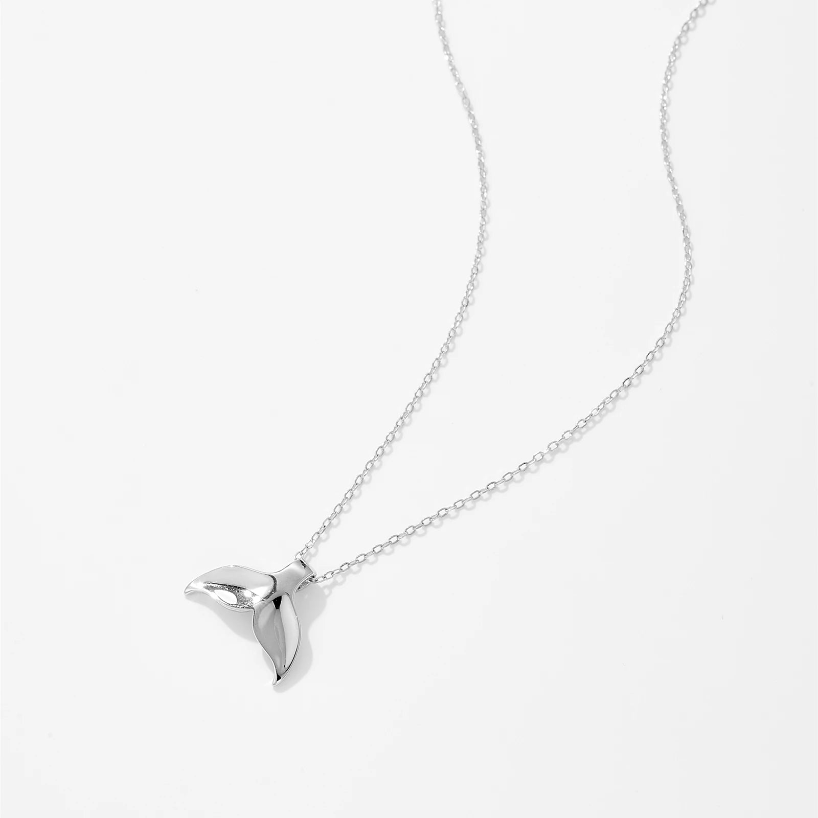 This silver jewelry dolphin tail pendant is a symbol of grace and freedom, designed to add a touch of elegance to any look. Crafted with high-quality materials, this circle necklace chain pendants piece shines beautifully, making it a standout accessory. Pair it effortlessly with bracelet jewelry and ear jewellery for a coordinated style. The delicate choker pendant design enhances its charm, perfect for both casual and formal wear.